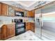 Updated kitchen with stainless steel fridge, granite countertops, and decorative wood cabinets at 27500 Breakers Dr, Wesley Chapel, FL 33544