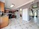 Bright kitchen features tile floors, stainless steel refrigerator, and decorative wood cabinets at 27500 Breakers Dr, Wesley Chapel, FL 33544