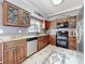 Updated kitchen featuring granite countertops, stainless steel appliances, and decorative wood cabinets at 27500 Breakers Dr, Wesley Chapel, FL 33544