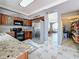 Open kitchen with granite counters, stainless steel refrigerator, and access to a pantry at 27500 Breakers Dr, Wesley Chapel, FL 33544