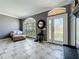 Elegant living room featuring decorative front door, tile floors, and abundant natural light at 27500 Breakers Dr, Wesley Chapel, FL 33544