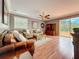 Bright living room featuring hardwood floors, comfortable sofas, and sliding glass doors to the patio at 27500 Breakers Dr, Wesley Chapel, FL 33544