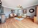 Open-concept living room with hardwood floors, stylish decor, and plenty of space for entertaining at 27500 Breakers Dr, Wesley Chapel, FL 33544