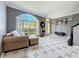 Inviting living room features an arched window, tile floors, and neutral decor at 27500 Breakers Dr, Wesley Chapel, FL 33544