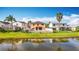 A view of the rear of the home showing a private yard, patio, and beautiful water view at 27500 N Breakers Dr, Wesley Chapel, FL 33544
