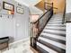 Staircase with elegant wooden railing and wainscoting at 27500 Breakers Dr, Wesley Chapel, FL 33544