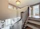 Upstairs landing with staircase and view of the front door and entry way at 27500 Breakers Dr, Wesley Chapel, FL 33544