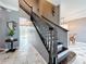 Staircase with dark wood railing and wrought iron spindles at 27500 Breakers Dr, Wesley Chapel, FL 33544