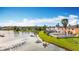 Scenic waterfront view of lush green lawns, and houses mirrored in the tranquil lake at 27500 Breakers Dr, Wesley Chapel, FL 33544