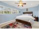 Comfortable bedroom with a plush rug, a ceiling fan, and bright natural light at 3333 San Bernadino St, Clearwater, FL 33759