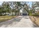 Well-maintained home with a spacious driveway, lush lawn, and mature trees providing ample shade at 3333 San Bernadino St, Clearwater, FL 33759