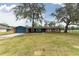 Charming single-story home with brick and siding, a long driveway, and mature trees at 36441 Lake Pasadena Rd, Dade City, FL 33525