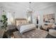 Bright bedroom with white walls, dark wood floors, chandelier, and seating area at 9050 San Martin Ne Blvd, St Petersburg, FL 33702