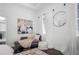Bedroom seating area with mirror, daybed, and modern artwork at 9050 San Martin Ne Blvd, St Petersburg, FL 33702