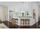 Kitchen bar with stool seating, white cabinets, marble countertops, and stainless steel appliances at 9050 San Martin Ne Blvd, St Petersburg, FL 33702