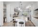 A spacious white kitchen with stone countertops and a view of the outdoor deck and backyard at 9050 San Martin Ne Blvd, St Petersburg, FL 33702