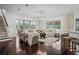 Spacious living room with hardwood floors, a sectional couch, and lots of natural light at 9050 San Martin Ne Blvd, St Petersburg, FL 33702