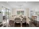 Open living area with floor to ceiling windows, hardwood floors, and a large sectional couch at 9050 San Martin Ne Blvd, St Petersburg, FL 33702