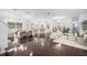 Open-concept living room with wood floors, a chandelier, bar seating, and plenty of natural light at 9050 San Martin Ne Blvd, St Petersburg, FL 33702