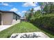 Large backyard with plenty of green space and a view of the screened-in pool at 10019 N Hyaleah, Tampa, FL 33617