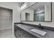 Bathroom featuring a double vanity with gray countertops and access to shower and closet at 10019 N Hyaleah, Tampa, FL 33617