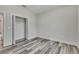 Bright bedroom featuring bi-fold closet doors, wood-look flooring and neutral wall paint at 10019 N Hyaleah, Tampa, FL 33617