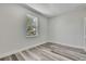 Sunlit bedroom with wood-look flooring, natural light, and modern gray walls at 10019 N Hyaleah, Tampa, FL 33617