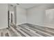 Neutral bedroom with gray wood-look floors, a door, and modern baseboards at 10019 N Hyaleah, Tampa, FL 33617
