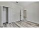 Bright bedroom showcasing wood-look flooring, closet, and a connected view to the adjacent room at 10019 N Hyaleah, Tampa, FL 33617