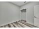 Clean bedroom featuring a built-in closet and stylish wood-look flooring for a modern feel at 10019 N Hyaleah, Tampa, FL 33617