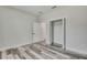 Inviting bedroom featuring wood-look flooring, open closet and doorway for flexible design options at 10019 N Hyaleah, Tampa, FL 33617