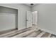 Bright bedroom with wood-look flooring, closet, and white trim for a modern, clean aesthetic at 10019 N Hyaleah, Tampa, FL 33617