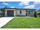 Charming single-story home featuring a well-maintained lawn, new driveway, and a convenient attached garage at 10019 N Hyaleah, Tampa, FL 33617