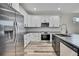 New kitchen showcasing stainless steel appliances, a gray island, and white cabinets with black hardware at 10019 N Hyaleah, Tampa, FL 33617