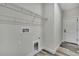 Functional laundry room featuring white walls, wood-look floors, and utility sink hookups at 10019 N Hyaleah, Tampa, FL 33617