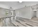 Spacious living room featuring new wood-look flooring, freshly painted walls, modern trim, and a ceiling fan at 10019 N Hyaleah, Tampa, FL 33617