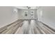 Spacious living room featuring new wood-look flooring, freshly painted walls, modern trim, and a ceiling fan at 10019 N Hyaleah, Tampa, FL 33617