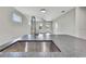 Open-concept floorplan with gray stained wood floors, white trim, and ample natural light at 10019 N Hyaleah, Tampa, FL 33617