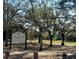 Entrance to Takomah Trail Park with a view of the walking path and green spaces under a canopy of trees at 10019 N Hyaleah, Tampa, FL 33617