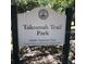 Takomah Trail Park signage with address and information, located within a green, outdoor community space at 10019 N Hyaleah, Tampa, FL 33617