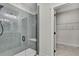 Modern shower featuring a glass enclosure, built-in bench, and access to walk-in closet at 10019 N Hyaleah, Tampa, FL 33617