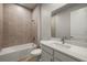 Bathroom features a shower over bath and a white vanity at 12193 Meditation Trl, Venice, FL 34293