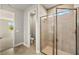 Bathroom featuring tiled walk-in shower and separate toilet room at 12193 Meditation Trl, Venice, FL 34293