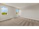 Carpeted bedroom featuring natural light from two windows at 12193 Meditation Trl, Venice, FL 34293