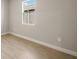 Empty bedroom featuring neutral walls and modern wood-look tile flooring at 12193 Meditation Trl, Venice, FL 34293
