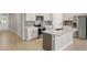 Beautiful kitchen boasting an island, modern appliances, and white cabinetry at 12193 Meditation Trl, Venice, FL 34293