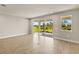 Bright living room boasts wood-look tile floors, recessed lighting, and sliding glass doors to the outdoors at 12193 Meditation Trl, Venice, FL 34293