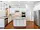 Modern kitchen featuring white cabinets, granite countertops, and stainless steel appliances at 2664 Keystone Springs Rd, Tarpon Springs, FL 34688