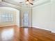 Bright living room with hardwood floors, transom windows, and archway entrance at 2664 Keystone Springs Rd, Tarpon Springs, FL 34688