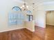 Bright living room with hardwood floors, plantation shutters, and decorative lighting at 2664 Keystone Springs Rd, Tarpon Springs, FL 34688